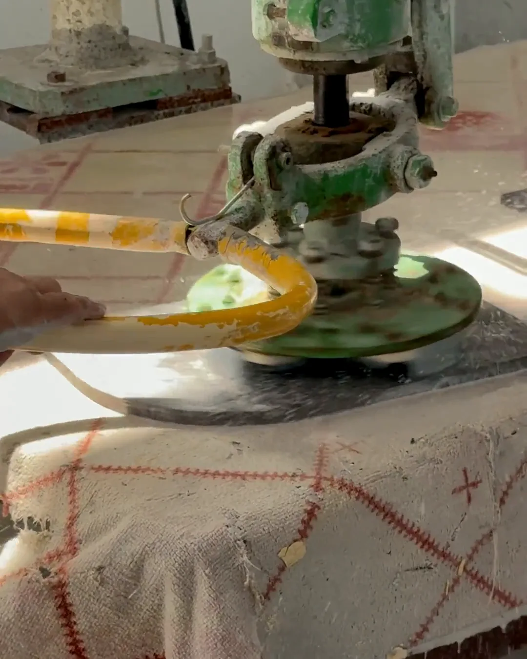 Craftsman finishing a marble surface with a hand polisher